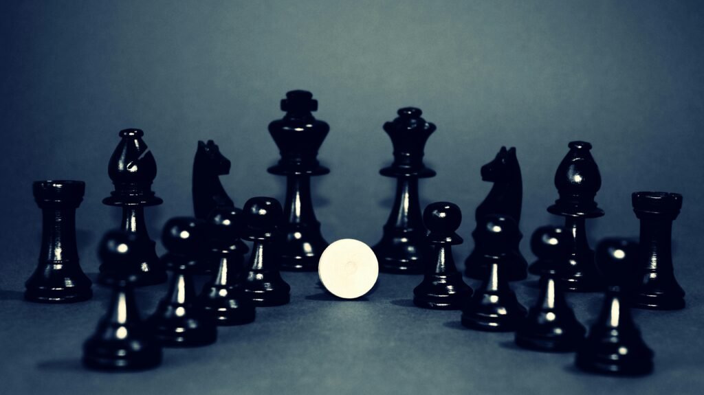 Elegant black chess pieces strategically displayed, creating a moody and strategic atmosphere.