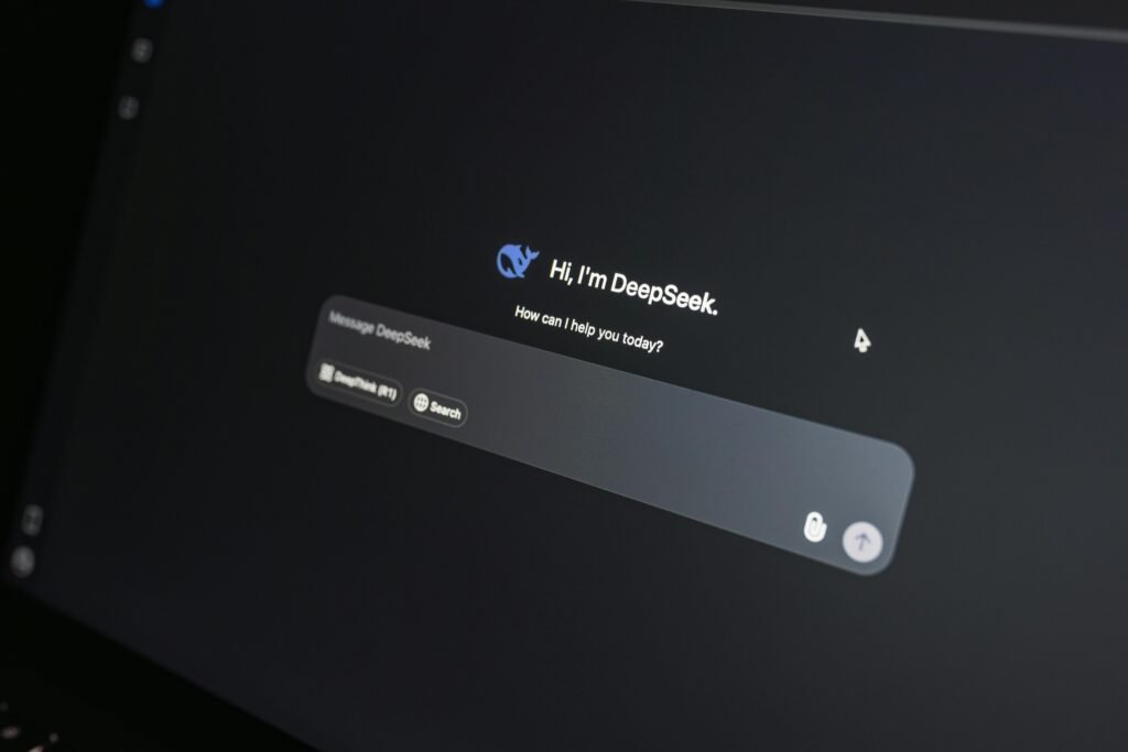 Close-up of DeepSeek AI chat interface on a laptop screen in low light.