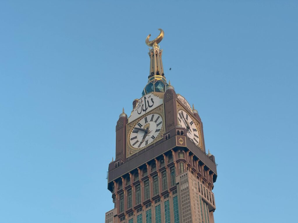 A stunning view of the Clock Tower at Abraj Al Bait, Mecca against a clear blue sky.