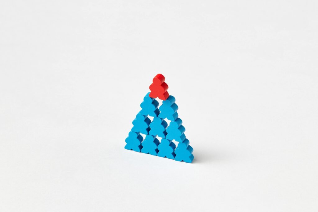 A stack of blue and red wooden blocks arranged in a triangle on a white background.